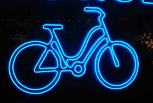 Art Display Featuring a Blue Neon Bicycle Sign that Captures Attention and Ambiance photo