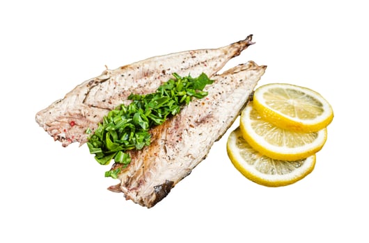 Delicious baked mackerel fillets with greens, garlic and lemon on wooden board. Isolated, white background. photo