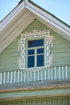 A Charming and Vintage Wooden House Featuring an Elaborate Decorative Window Design photo