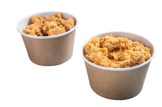 Crunchy chicken popcorn bites in a basket from fastfood. Isolated on white background photo