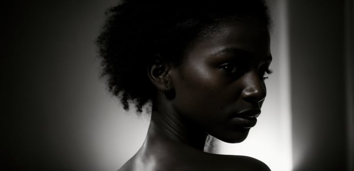 A black woman with a black background photo