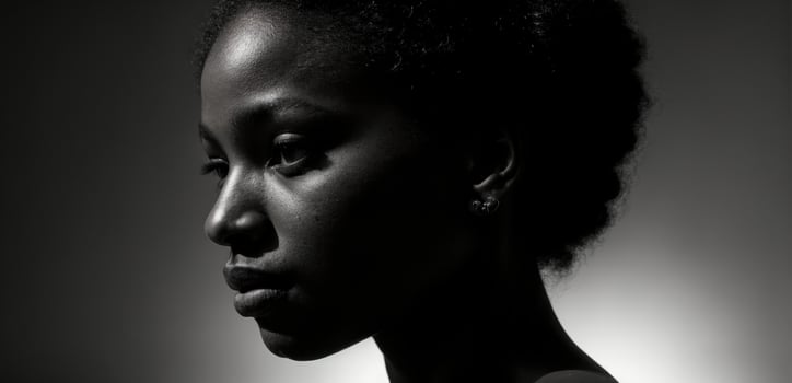 A black woman with a dark background photo