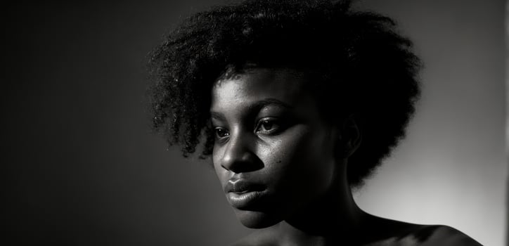A black and white photo of a woman with an afro