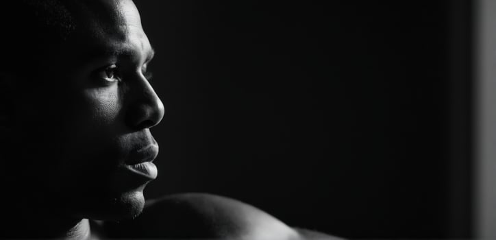 A man in black and white looking away from the camera photo