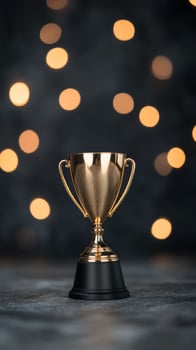 Golden trophy with bokeh lights on a dark background during a celebration event photo