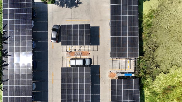 An overhead view of a parking lot with solar panels photo