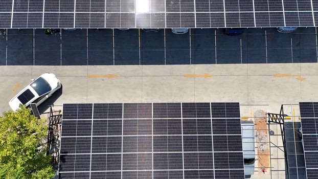 An overhead view of a parking lot with solar panels photo