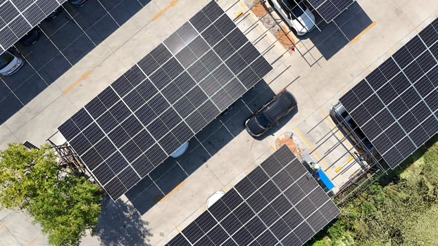 An overhead view of a parking lot with solar panels photo