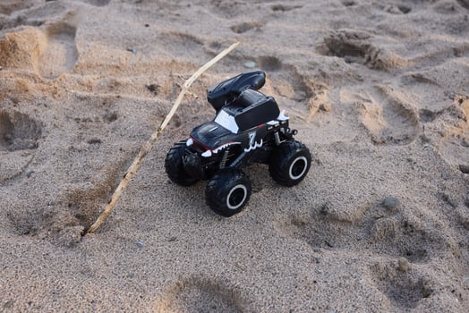 Experience the thrill of a RemoteControlled Monster Truck driving across a sandy beach photo