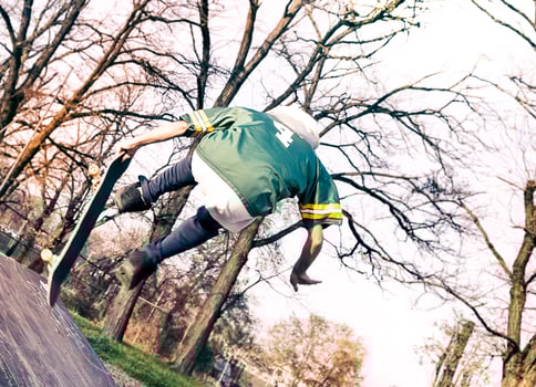 young skateboarder jumping on a ramp outdoor photo
