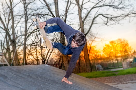 young skateboarder jumping on a ramp outdoor photo