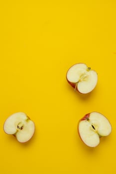 Flat lay composition with many red apples on yellow background. Space for text photo