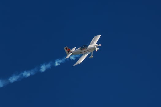 Stunt aerobatic plane performing stunts in air photo