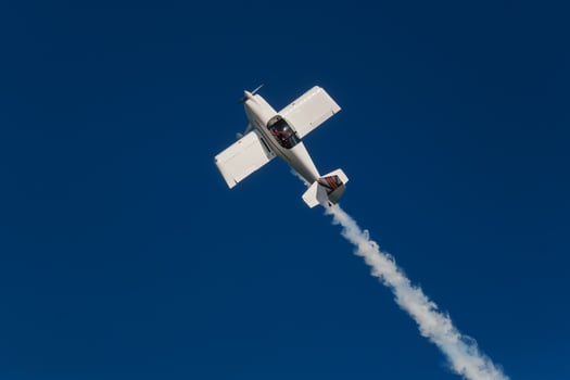 Stunt aerobatic plane performing stunts in air photo