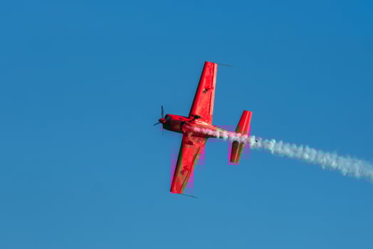 Stunt aerobatic plane performing stunts in air photo