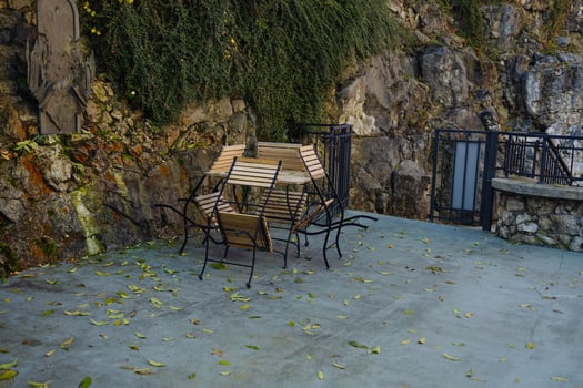 Outdoor dining patio with plants , empty, no people restaurant outside seating tables chairs photo