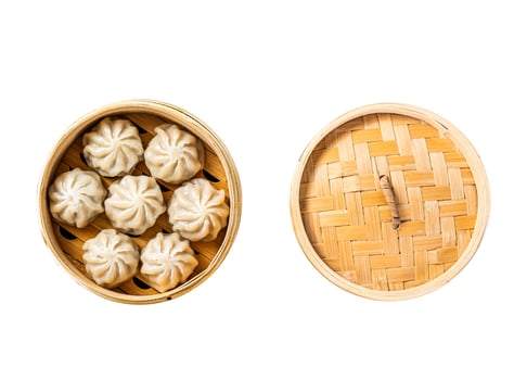 Momo dumplings in a bamboo steamer. Isolated, white background. Top view. photo