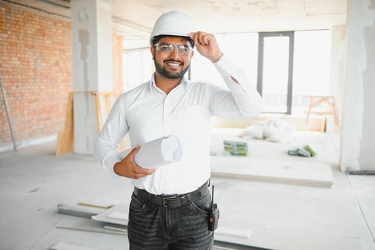 Male architect in hard hat at construction site photo