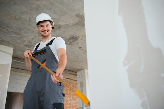 painter man painting the wall, with paint roller photo