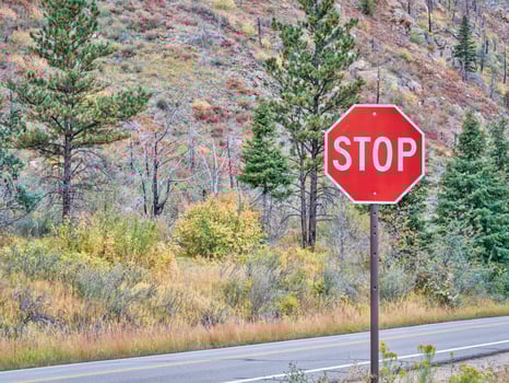 stop sign on a mountain highway photo