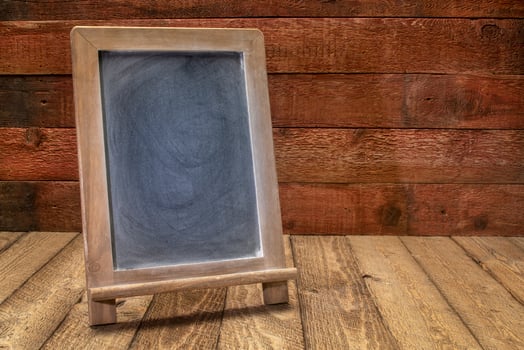 blank blackboard sign on rustic wood photo