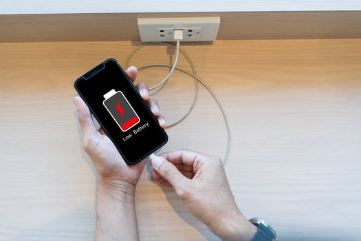 Close up man's hands using smart phone battery low charge battery screen, Businessman holding a smartphone Low battery photo