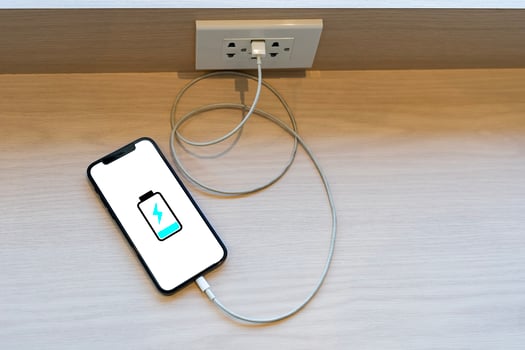 Close up smartphone battery low charge battery screen, Businessman holding a smartphone. photo