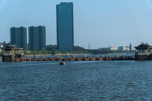 A modern cityscape blended with traditional architecture, elegantly situated over water photo