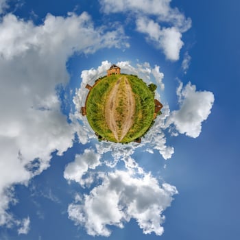 tiny planet in blue sky with clouds of old abandoned ruined church. Transformation of spherical 360 panorama in abstract aerial view. photo