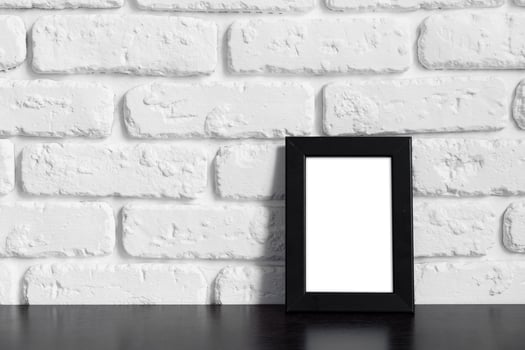 Photo frame with copy space against white brick wall