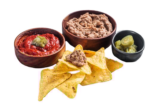 Nachos chips with tomato sauce and jalapeno, mexican appetizer. Isolated, white background. photo