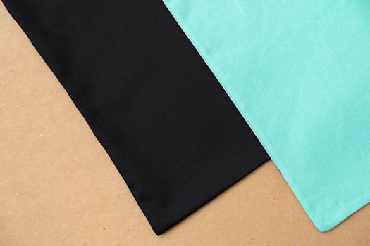 Black textile shopping bag on beige background flat lay photo