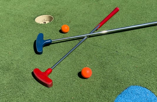 Closeup of player play mini golf with ball photo