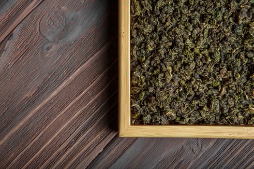 Premium HighQuality Dried Cannabis Leaves Beautifully Arranged in a Wooden Tray photo