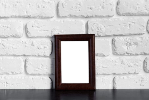 Photo frame with copy space against white brick wall