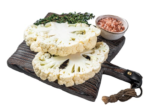 Cooking of cauliflower steak, Vegetarian cuisine. Isolated, white background. photo