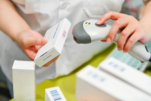 Pharmacist scanning barcode of medicine drug in a pharmacy drugstore photo
