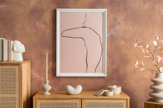 Creative composition vintage living room with rattan chest of drawers, vase with dried flowers, casket, candlestick and minimalistic poster. Stylish accessories. Mock up poster. Template. photo