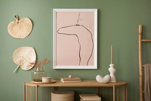 Stylish living room interior design with mock up poster frames, wooden chest of drawers, brown vase and creative home accessories. Sage green wall. Template. photo