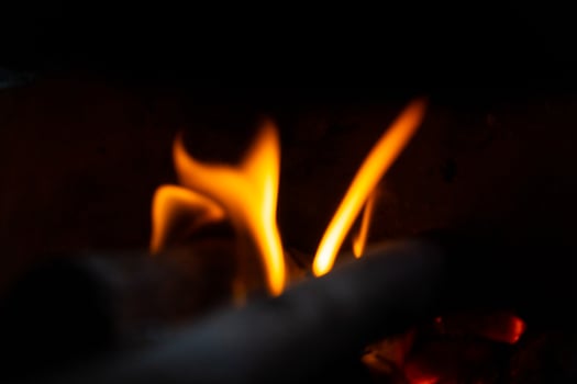 Burning wood branch texture for warm and atmospheric backgrounds in creative or professional projects photo