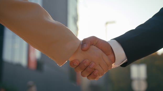 Close up business handshake together businessman businesswoman female male hands partnership meeting corporate cooperation success businesspeople collaboration colleagues handshaking in city sun light photo