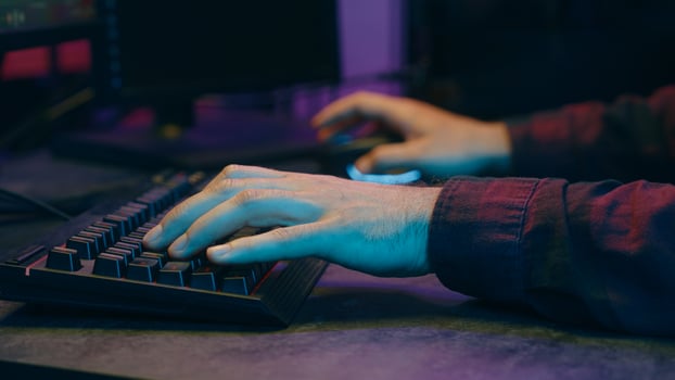 Carefree Caucasian gamer guy blogger vlogger man playing computer game at home neon night cyber sport online gaming app Internet male influencer recording vlog blog addicted streamer host stream photo