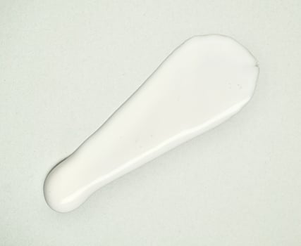 White lotion cream swatch texture isolated on horizontal white background. photo
