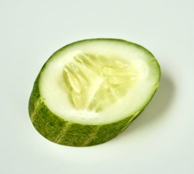 One piece of fresh and healthy cucumber vegetable slice isolated on white square background. photo