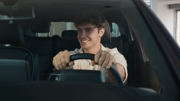 Caucasian happy carefree cheerful man buyer owner of new car guy successful businessman sitting inside automobile celebrate auto transport vehicle buying purchase dancing enjoy music at radio achieve photo