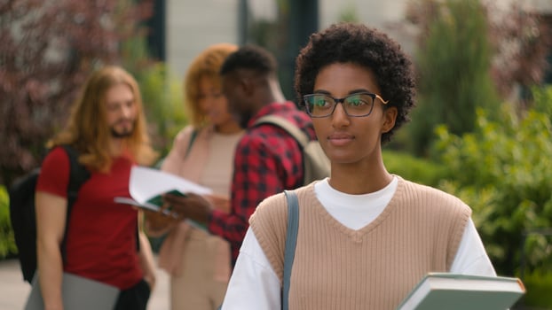 African American young student woman high school schoolgirl smiling toothy happy pupil girl outdoors after university lesson education knowledge on background of talking diverse multiracial students photo