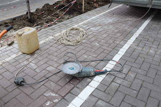 Various Outdoor Construction Tools and Equipment Used on a Paved Surface for Projects photo