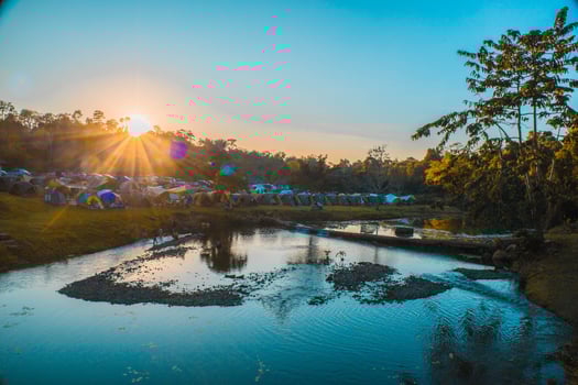 A campsite with a clear blue sky and reflections in the water, National park, Thailand. photo