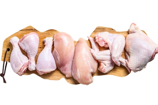 Raw uncooked chicken meat on a cutting board. Isolated on white background. photo