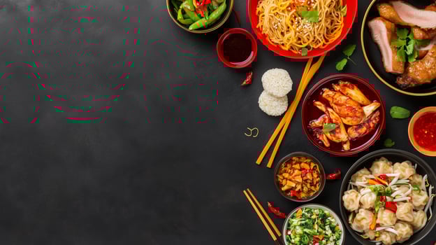 Colorful assortment of Asian dishes served on a dark table with chopsticks and sauces photo